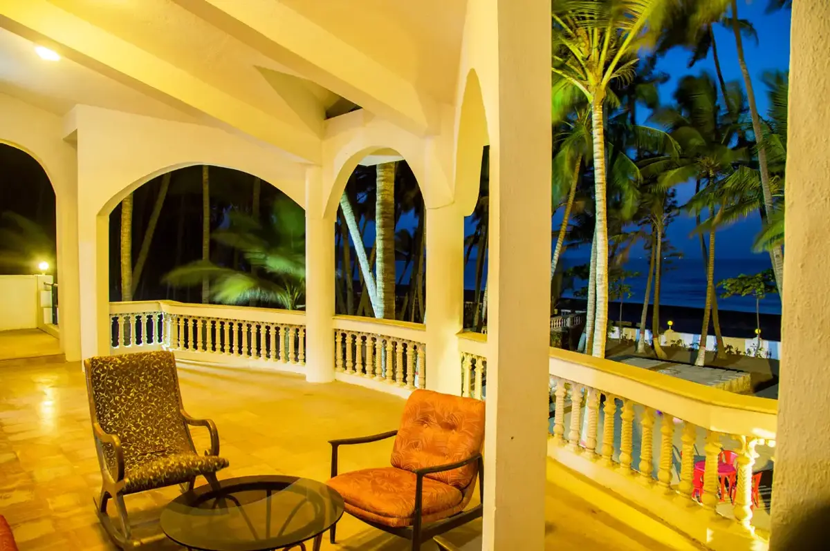 Villa veranda overlooking the beach and coconut palms